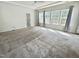 Spacious bedroom with large windows offering ample natural light and plush carpeting at 8813 Moss Glen Dr, Raleigh, NC 27617