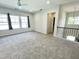Expansive bonus room boasts neutral carpet, ample natural light, and access to upstairs hallway at 8813 Moss Glen Dr, Raleigh, NC 27617