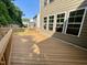Wood deck with railings, offering a view of the surrounding backyard and trees at 8813 Moss Glen Dr, Raleigh, NC 27617