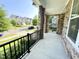 Spacious front porch featuring stone accents and black railings, with a pleasant neighborhood view at 8813 Moss Glen Dr, Raleigh, NC 27617
