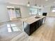 Kitchen featuring a large island with a sink, dark wood cabinets, and stainless appliances at 8813 Moss Glen Dr, Raleigh, NC 27617