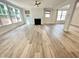 Spacious living room featuring hardwood floors, a cozy fireplace, and large windows, bathed in natural light at 8813 Moss Glen Dr, Raleigh, NC 27617