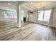 Bright living space with hardwood floors, fireplace, and ample natural light, creating an inviting atmosphere at 8813 Moss Glen Dr, Raleigh, NC 27617