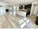 Expansive living space featuring hardwood floors, a large island, and dark kitchen cabinets, ideal for entertaining at 8813 Moss Glen Dr, Raleigh, NC 27617