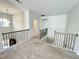 Loft area with plush carpet, a decorative light fixture, and views of the downstairs area at 8813 Moss Glen Dr, Raleigh, NC 27617