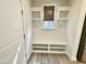 Mudroom area with custom built-in shelving, a bench, and hooks at 8813 Moss Glen Dr, Raleigh, NC 27617