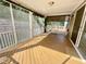 Screened-in porch with wood flooring, providing a comfortable outdoor living space at 8813 Moss Glen Dr, Raleigh, NC 27617