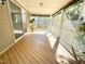 Screened-in porch with wood flooring, offering an inviting space to enjoy the outdoors bug-free at 8813 Moss Glen Dr, Raleigh, NC 27617