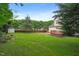 This home features a backyard with a lush lawn, wood deck, and privacy fence at 900 Borage Dr, Wake Forest, NC 27587
