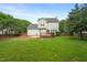 This home features a backyard with a lush lawn, wood deck, and privacy fence at 900 Borage Dr, Wake Forest, NC 27587