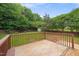 This backyard deck with brown railings overlooks the yard at 900 Borage Dr, Wake Forest, NC 27587