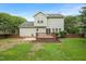 This home features a backyard with a lush lawn, wood deck, and privacy fence at 900 Borage Dr, Wake Forest, NC 27587