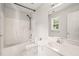 Well-lit bathroom featuring a tub-shower combo, a sink, and a large mirror at 900 Borage Dr, Wake Forest, NC 27587