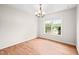 Bright dining room with hardwood floors, a window for natural light, and an elegant chandelier at 900 Borage Dr, Wake Forest, NC 27587