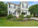 Beautiful landscaping and garden beds accent the front of this well-maintained two-story home at 900 Borage Dr, Wake Forest, NC 27587