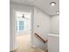 Bright hallway with carpeted floors leading to a bedroom with a ceiling fan and natural light at 900 Borage Dr, Wake Forest, NC 27587