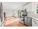 Kitchen and breakfast nook with stainless steel appliances and slider to rear deck at 900 Borage Dr, Wake Forest, NC 27587