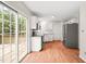 Modern kitchen with stainless steel appliances, white cabinets, granite counters, and wood flooring at 900 Borage Dr, Wake Forest, NC 27587