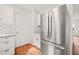 Modern kitchen with stainless steel refrigerator, white cabinets and subway tile at 900 Borage Dr, Wake Forest, NC 27587