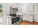 Bright kitchen features white cabinets, subway tile backsplash, and stainless steel appliances at 900 Borage Dr, Wake Forest, NC 27587
