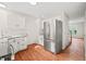 Spacious kitchen with stainless steel refrigerator, granite counters, and white cabinetry at 900 Borage Dr, Wake Forest, NC 27587