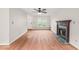 Spacious living room featuring hardwood floors, a cozy fireplace, and natural light from a window at 900 Borage Dr, Wake Forest, NC 27587