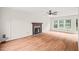 Hardwood floors and a traditional fireplace highlight the living room's inviting and comfortable space at 900 Borage Dr, Wake Forest, NC 27587
