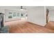 Bright living room with hardwood floors, a fireplace, sliding glass doors, and staircase access at 900 Borage Dr, Wake Forest, NC 27587