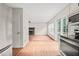 Open concept living room with wood floors, fireplace, and sliding glass doors to deck at 900 Borage Dr, Wake Forest, NC 27587