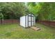 This backyard features a white outdoor shed with double doors for plenty of storage at 900 Borage Dr, Wake Forest, NC 27587