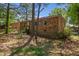 Backyard featuring back of brick home and storage shed at 903 Da Vinci St, Durham, NC 27704