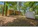 Backyard featuring brick home, trees and shed at 903 Da Vinci St, Durham, NC 27704