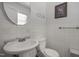 Half bathroom with toilet and sink with artwork on the walls at 903 Da Vinci St, Durham, NC 27704