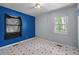 Bedroom featuring bright blue accent wall and window for natural light at 903 Da Vinci St, Durham, NC 27704