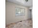 View of bedroom with a single window and damaged floor at 903 Da Vinci St, Durham, NC 27704