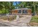 Charming single-story home featuring a brick and siding exterior with a fenced yard and mature trees at 903 Da Vinci St, Durham, NC 27704