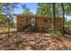 Back exterior of brick home showing access to backyard and trees at 903 Da Vinci St, Durham, NC 27704