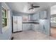 Functional kitchen with retro light blue wall, white appliances, and classic cabinetry at 903 Da Vinci St, Durham, NC 27704