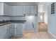 Features blue cabinets and a tile floor that needs repair at 903 Da Vinci St, Durham, NC 27704
