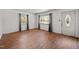 Bright living room with hardwood floors, and ample natural light from the windows and front door at 903 Da Vinci St, Durham, NC 27704