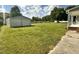View of a detached garage and spacious backyard with a large grassy area at 940 Pamela Ln, Rocky Mount, NC 27803