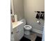 Cozy powder room features a sink with cabinet, toilet, and charming towel rack accents at 940 Pamela Ln, Rocky Mount, NC 27803