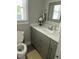 Clean bathroom featuring a gray vanity with marble countertop, new faucet, and plenty of natural light at 940 Pamela Ln, Rocky Mount, NC 27803