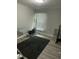 Bright bedroom space featuring an exercise machine, large window and modern flooring at 940 Pamela Ln, Rocky Mount, NC 27803