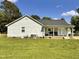 Home with a side porch, grill, light gray siding and a brick foundation at 940 Pamela Ln, Rocky Mount, NC 27803