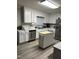 Bright kitchen features white cabinets, stainless steel appliances, and a convenient kitchen island at 940 Pamela Ln, Rocky Mount, NC 27803
