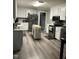 Spacious kitchen with stainless steel appliances, center island, and stylish vinyl flooring at 940 Pamela Ln, Rocky Mount, NC 27803