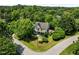 Aerial view of a beautiful two-story home surrounded by lush trees and greenery at 100 Michaels Way, Chapel Hill, NC 27516