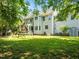 Expansive backyard with a playset, screened porch, and a well-maintained lawn at 100 Michaels Way, Chapel Hill, NC 27516