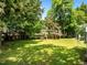 Lush backyard with a swingset, mature trees, and green grass at 100 Michaels Way, Chapel Hill, NC 27516